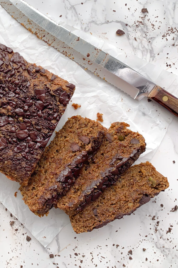 three slices of healthy breakfast bread on parchment paper with a knife