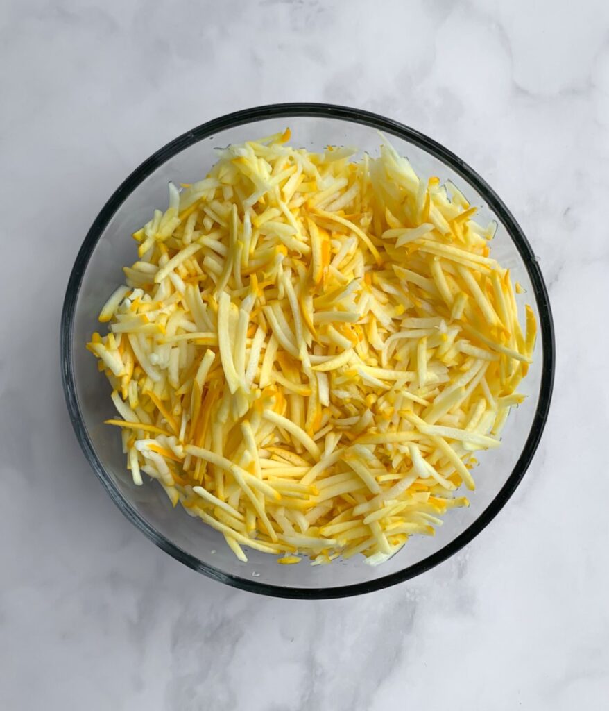 shredded yellow zucchini in a bowl