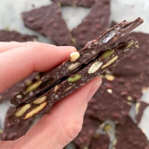 magnesium chocolate bark between thumb and index finger