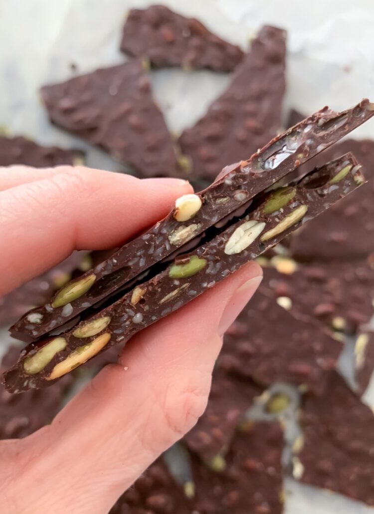 magnesium chocolate bark between thumb and index finger