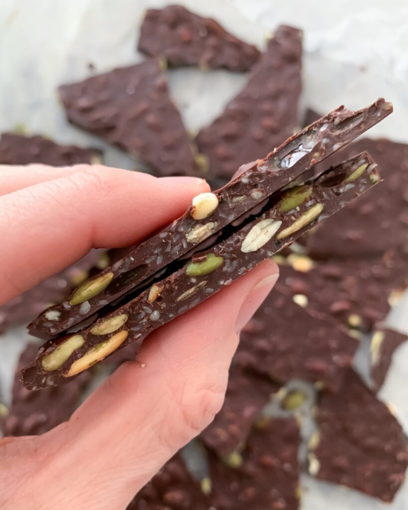 magnesium chocolate bark between thumb and index finger