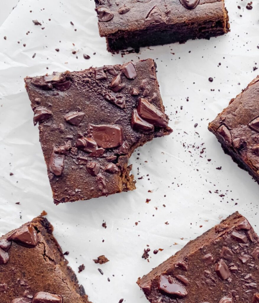 close up of cut brownies, one with a bite taken from it.