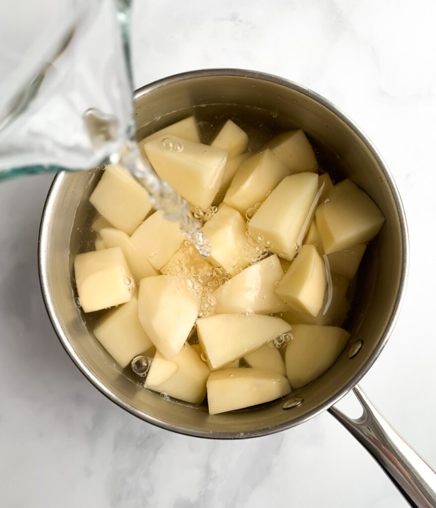 peeled and chopped potatoes in a pot with water