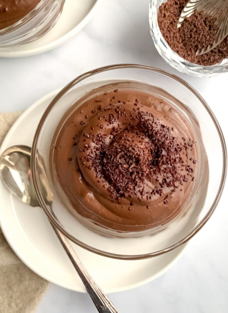 chocolate chia pudding swirled in a dessert dish bowl, topped with chocolate shavings.