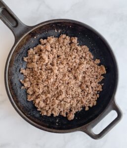 cast iron skillet with cooked ground beef