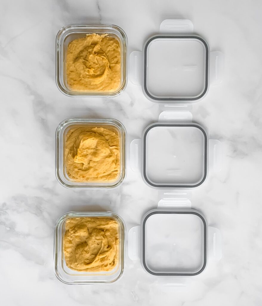 taco hummus in small square glass containers with lids to the side