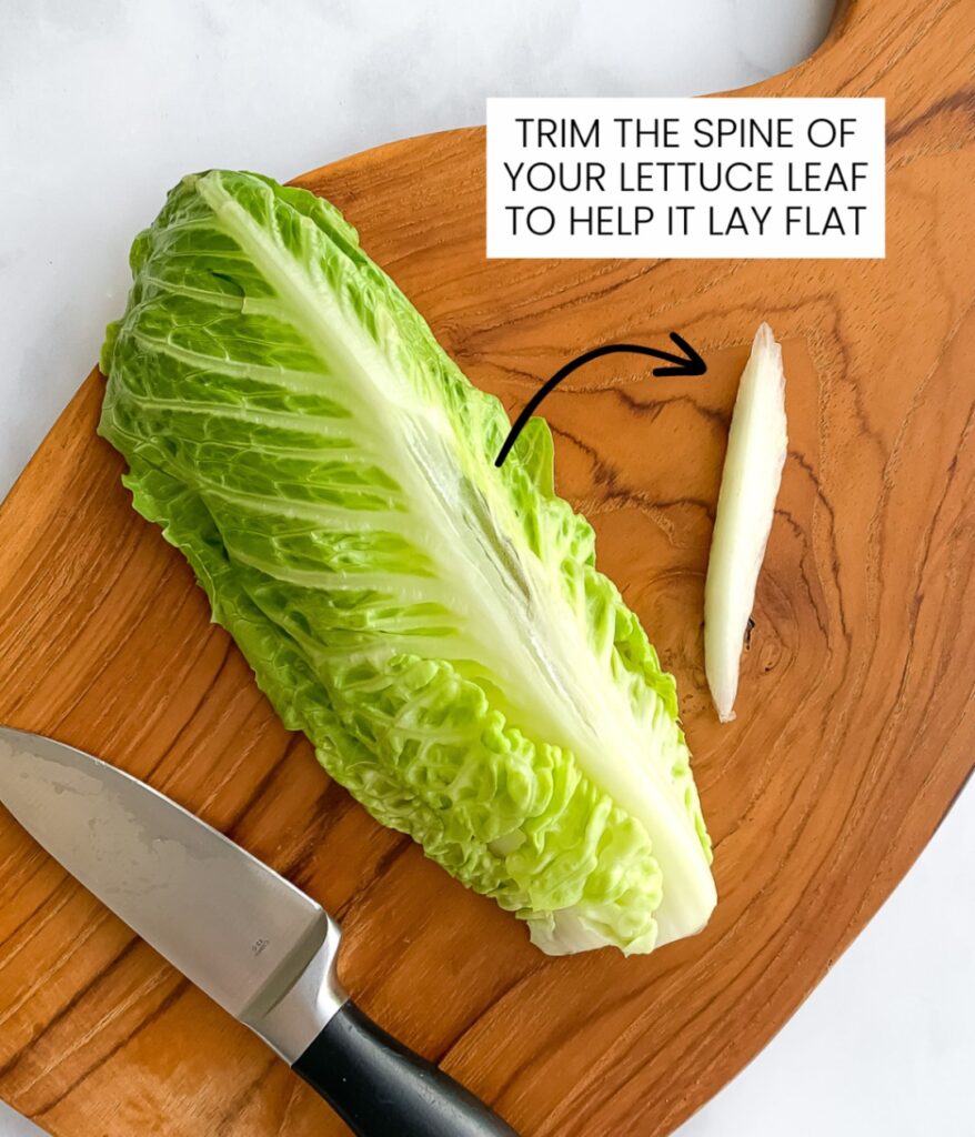 romaine heart lettuce leaf on a cutting board with a knife