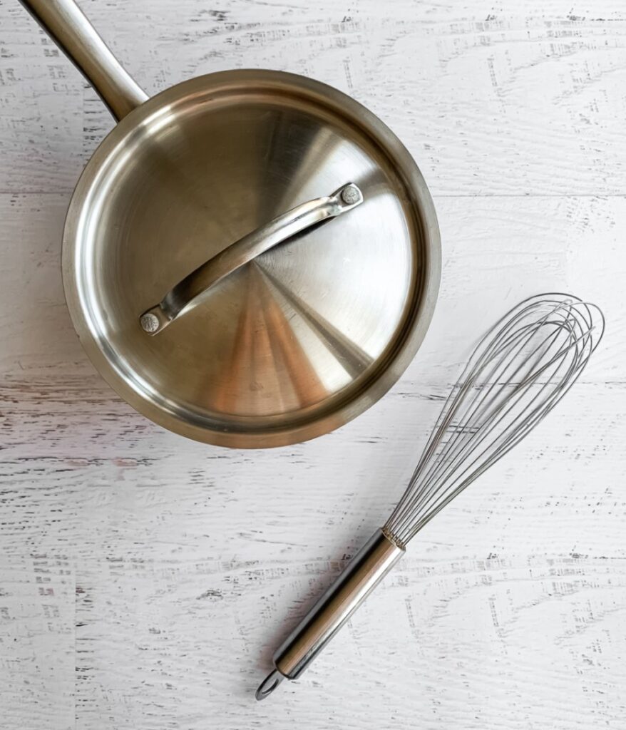 saucepan with lid and whisk