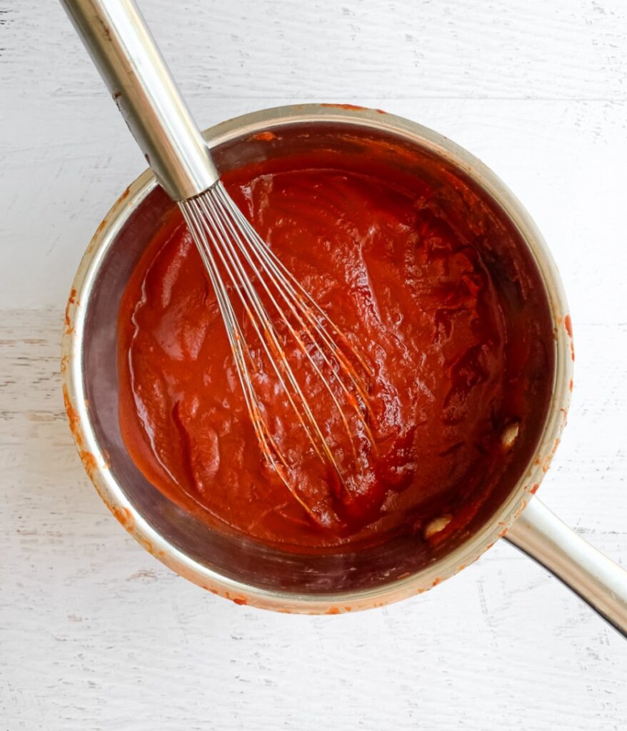 ketchup in a pot with a whisk