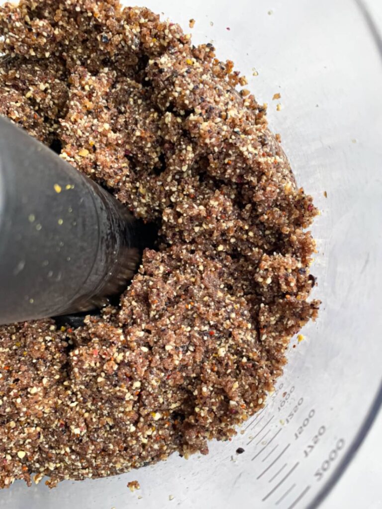 Blueberry energy ball mixture in a food processor after blending the ingredients together
