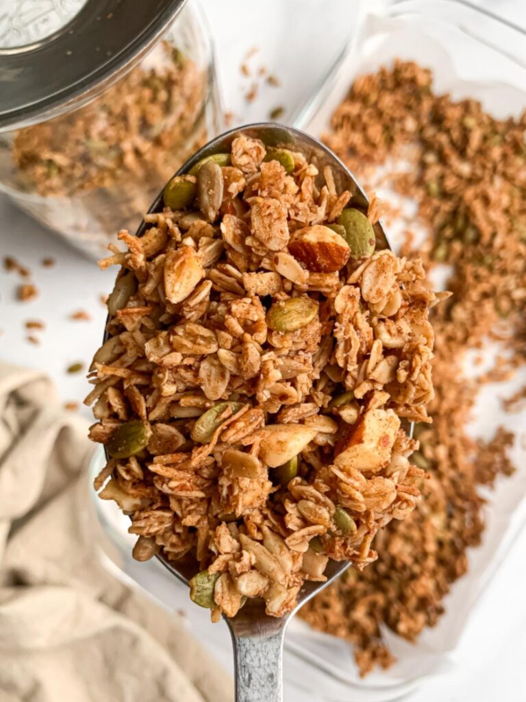 close up of granola clusters on a large spoon showing their texture