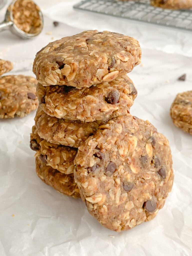 chocolate chip no bake cookies made with oats as a make-ahead healthy snack for kids, 5 stacked on top of each other with ingredients in background.