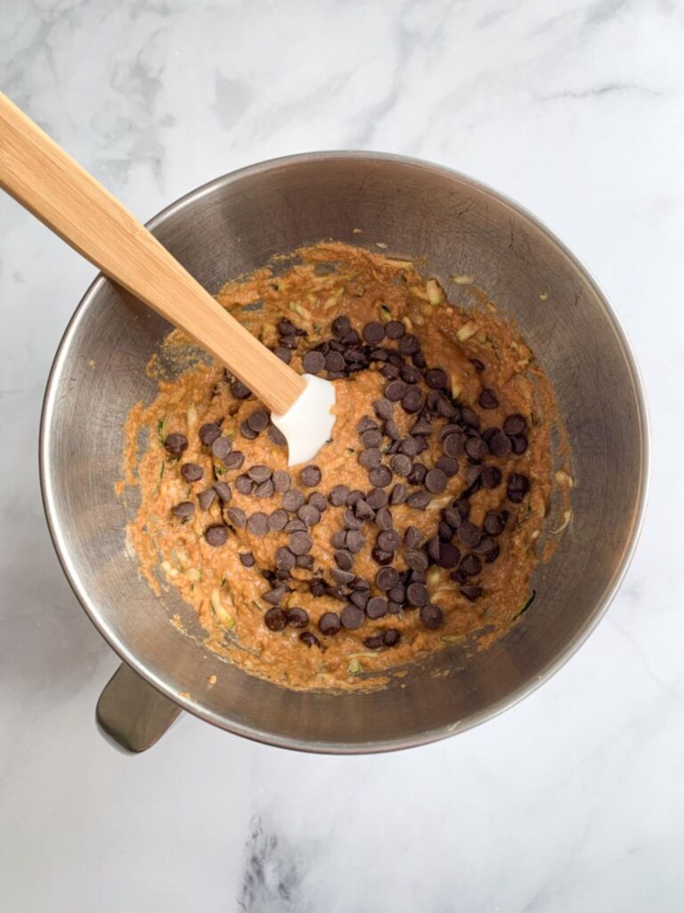 healthy chocolate chip zucchini muffin batter in a bowl.