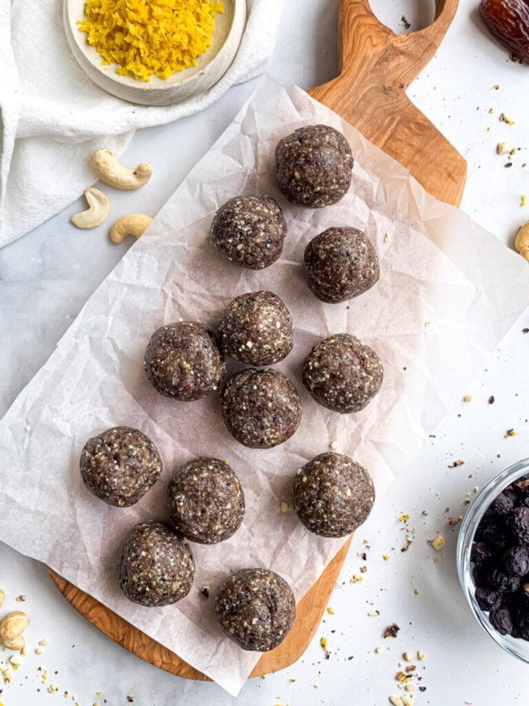 Homemade lemon blueberry energy balls arranged on parchment paper