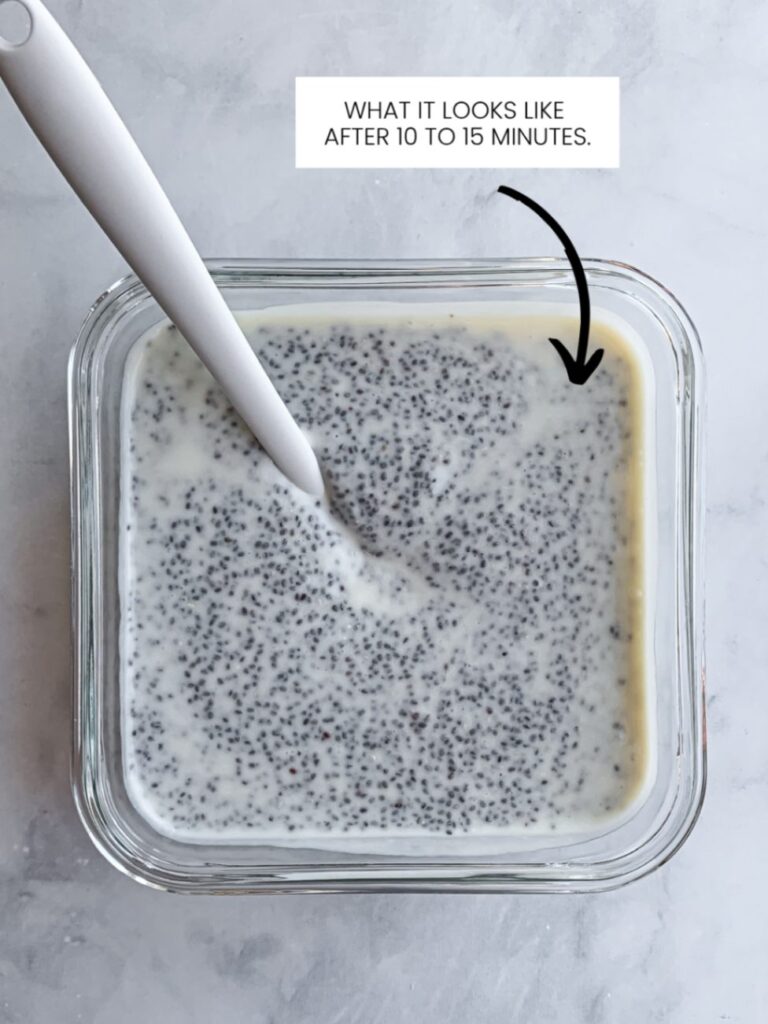 glass storage container with partially set chia pudding mixture and mini spatula